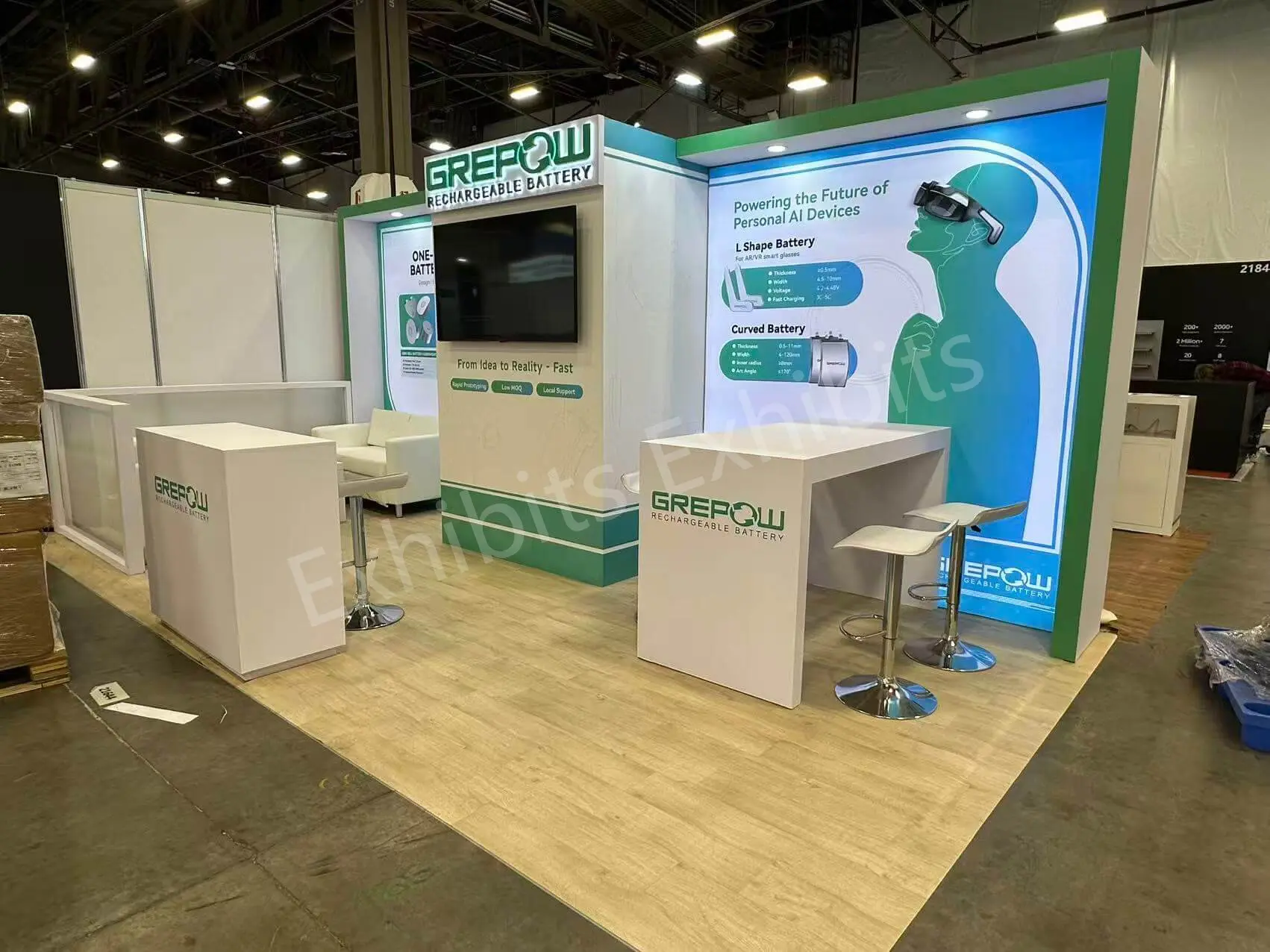 GREPOW booth at CES 2026 with central monitor tower, branded counters and green graphics