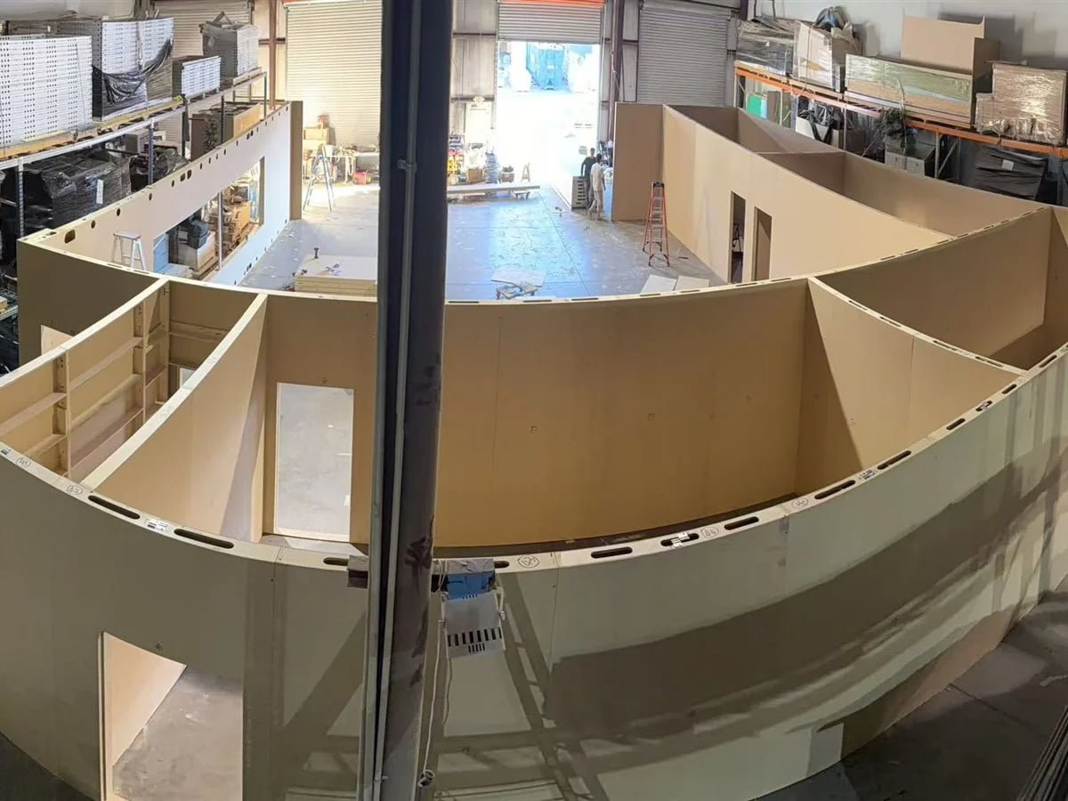 Pre-show assembly area with booth sections being staged