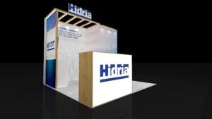 Perspective of EXM-1010-003 10x10 booth with wood-look overhead frame, raised logo sign and reception counter