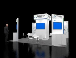 20x20 booth EXM-2020-003 with central brand tower, monitor stations and white meeting furniture